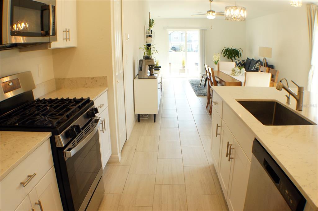 1714 Lanier Road Zephyrhills, FL 33541 - Photo 3 of 23 a kitchen with a sink stove and cabinets