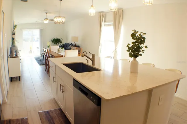 a kitchen with a sink a counter space and wooden floor