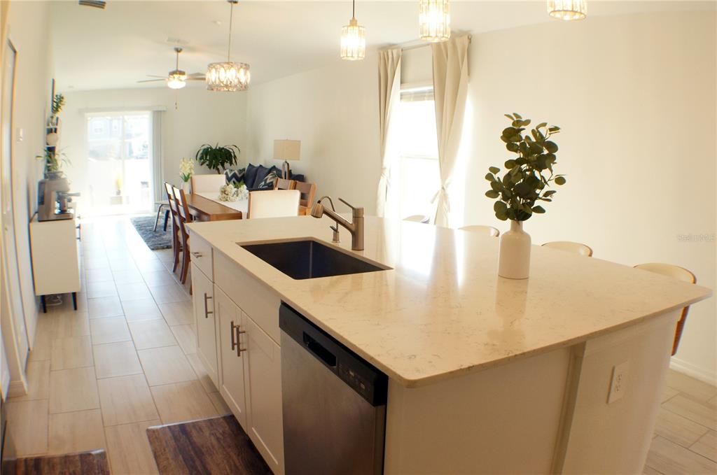 1714 Lanier Road Zephyrhills, FL 33541 - Photo 4 of 23 a kitchen with a sink a counter space and wooden floor