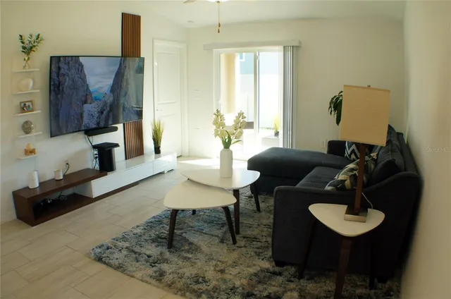 a living room with furniture and a wooden floor