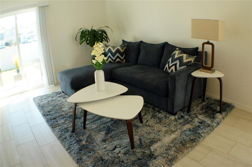1714 Lanier Road Zephyrhills, FL 33541 - Photo 7 of 23 a living room with furniture flowerpot and a rug