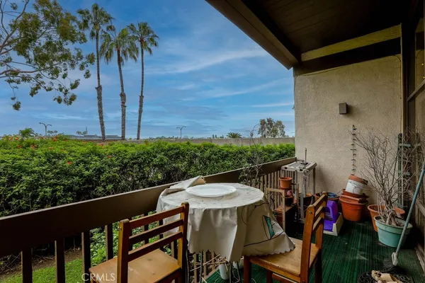 a view of a chairs and table in the balcony