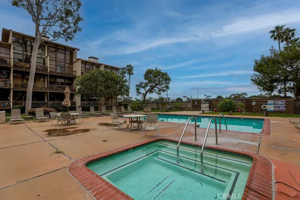 a view of a swimming pool with lounge chairs