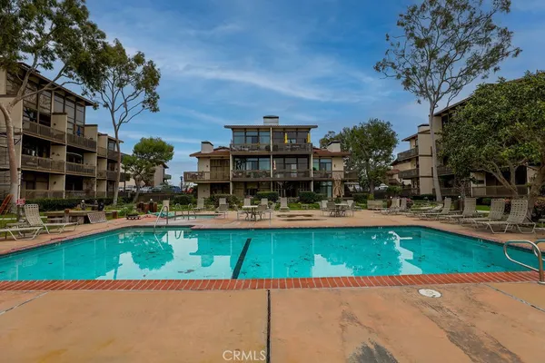 a swimming pool with outdoor seating and yard