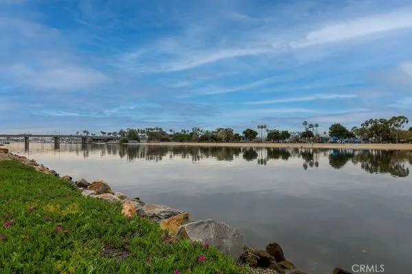 a view of a lake with houses in the back