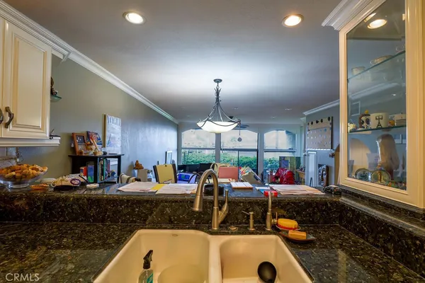 a kitchen with stove and a dining table with chairs
