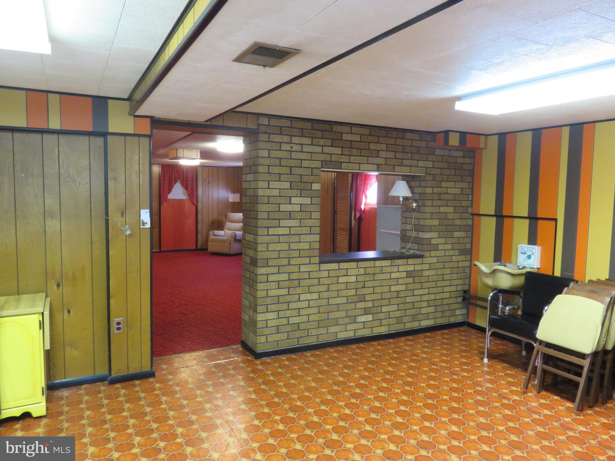 1710 Orlando Road Baltimore, MD 21234 - Photo 25 of 32 a view of a hallway with a chair and dining table