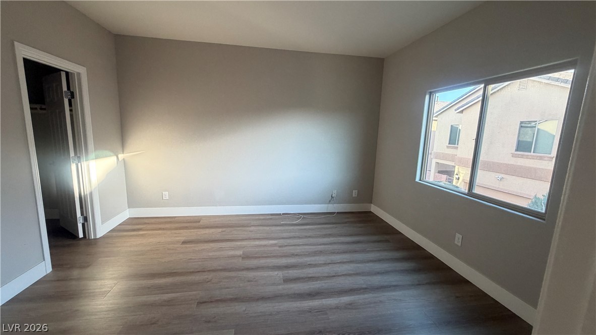 9453 Alma Ridge Avenue Las Vegas, NV 89178 - Photo 8 of 25 Laminate flooring extends through this room, with a generous window inviting ample daylight.