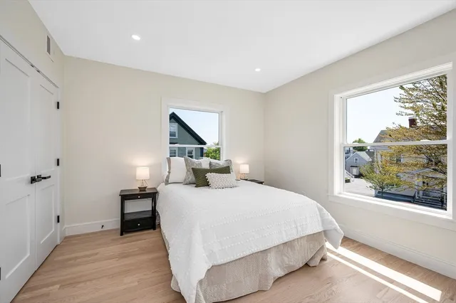 a bedroom with a large bed and a window