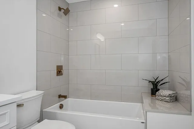 a bathroom with a bathtub and a toilet