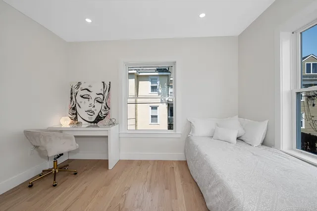 a bedroom with a bed and a desk