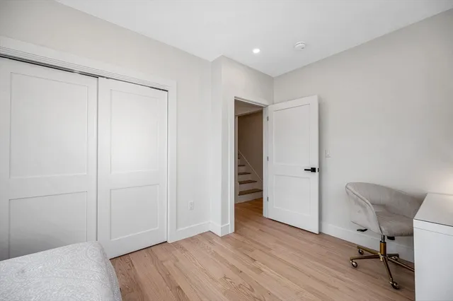 a view of a room with wooden floor cabinet and a bathroom