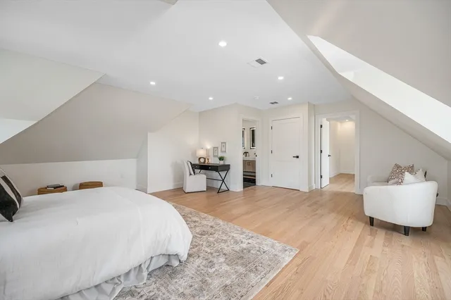 a spacious bedroom with a bed and a couch