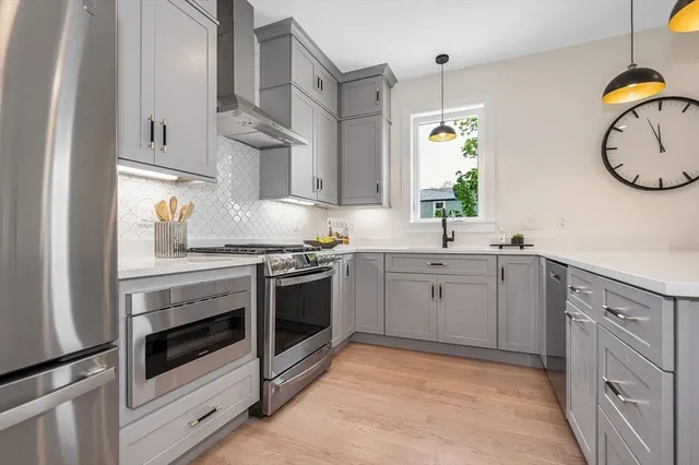 a kitchen with cabinets appliances and a window