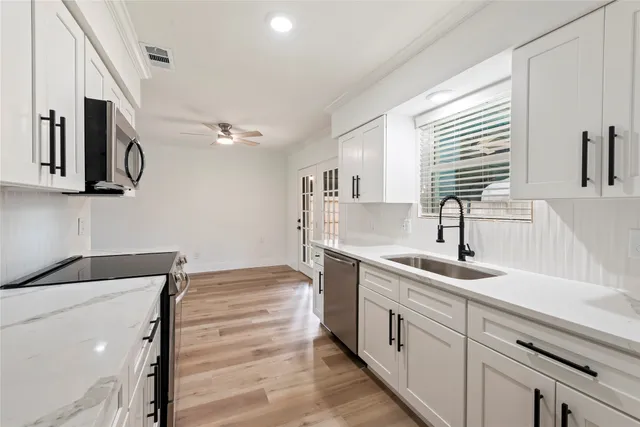 a kitchen with a sink and cabinets