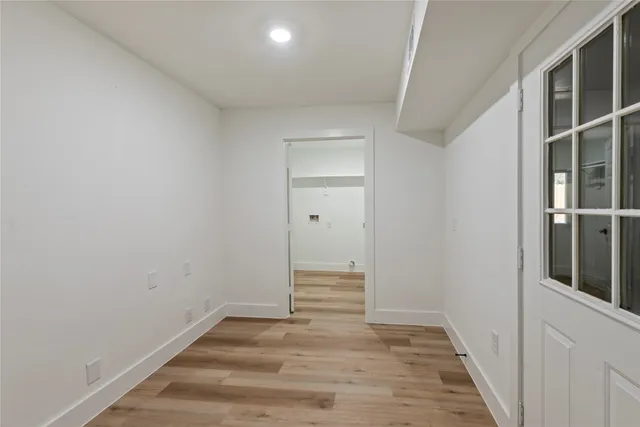 a view of a hallway with wooden floor