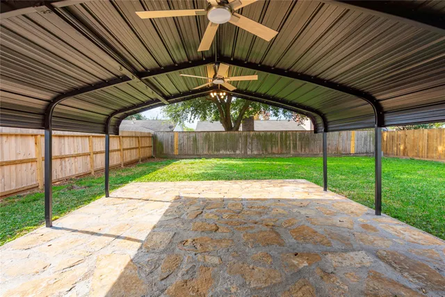 a view of a yard with wooden fence