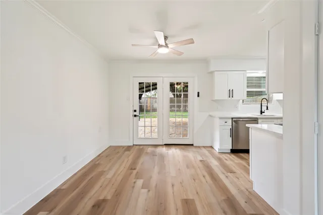 a room with a white cabinets and wooden floor