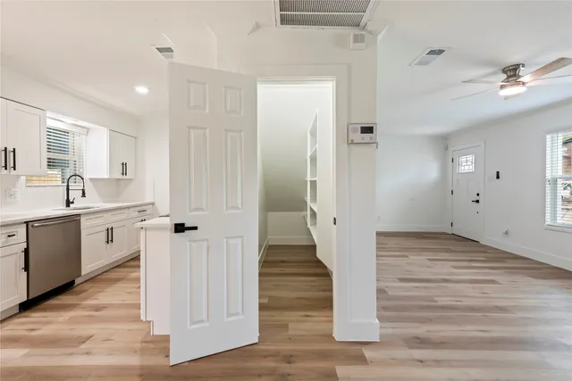 a view of a hallway with wooden floor and staircase