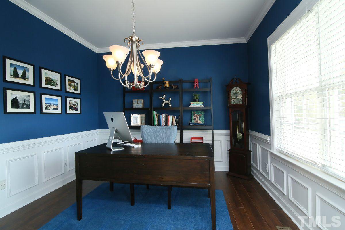 9212 Pennythorne Court Raleigh, NC 27615 - Photo 11 of 25 a dining room with wooden floor a chandelier a wooden table and chairs