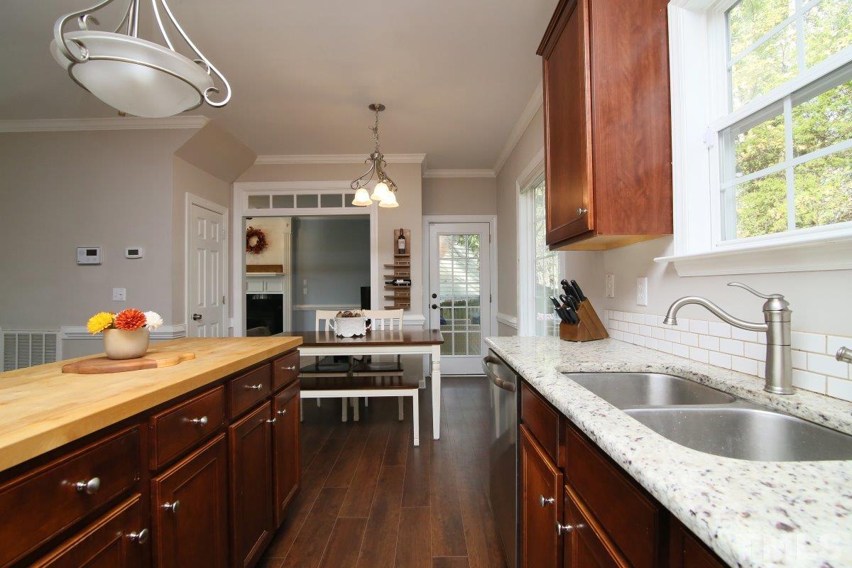 9212 Pennythorne Court Raleigh, NC 27615 - Photo 13 of 25 a kitchen with a sink cabinets and window