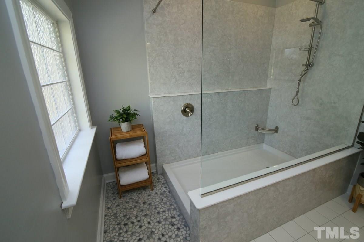 9212 Pennythorne Court Raleigh, NC 27615 - Photo 20 of 25 a bathroom with a shower and toilet