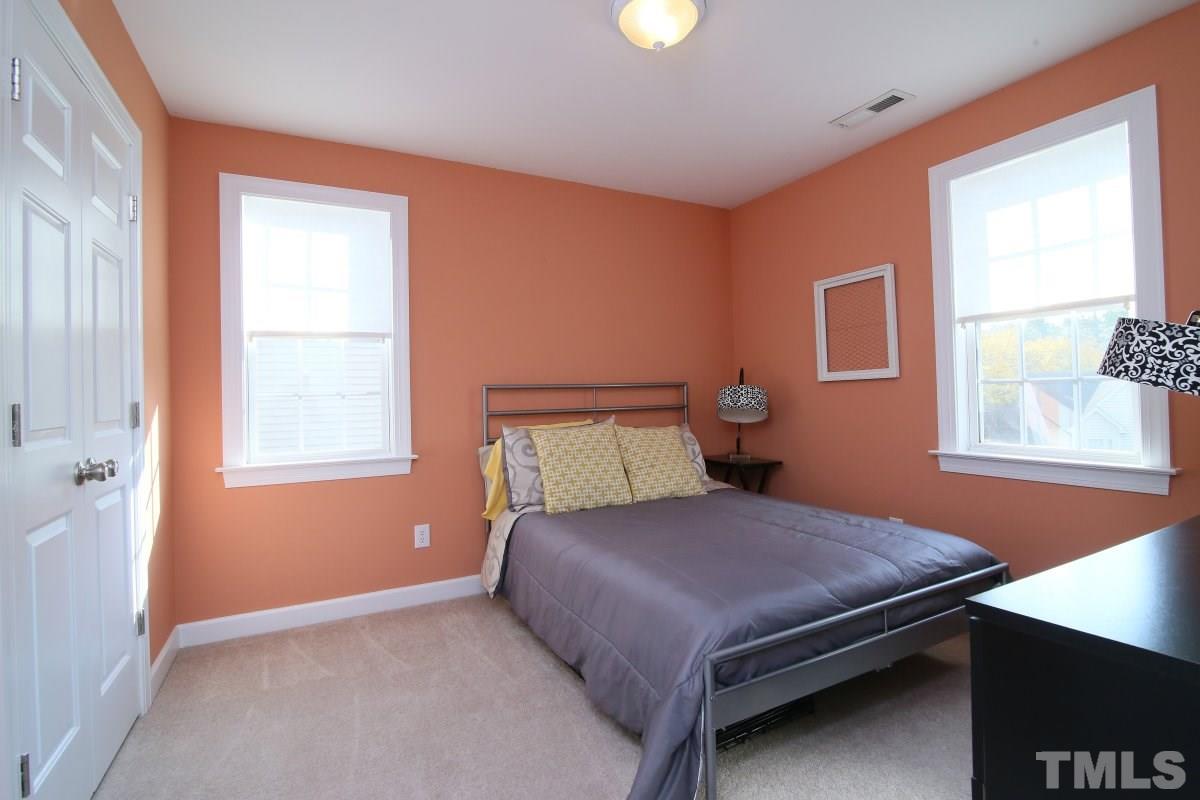 9212 Pennythorne Court Raleigh, NC 27615 - Photo 23 of 25 a bedroom with a bed and window