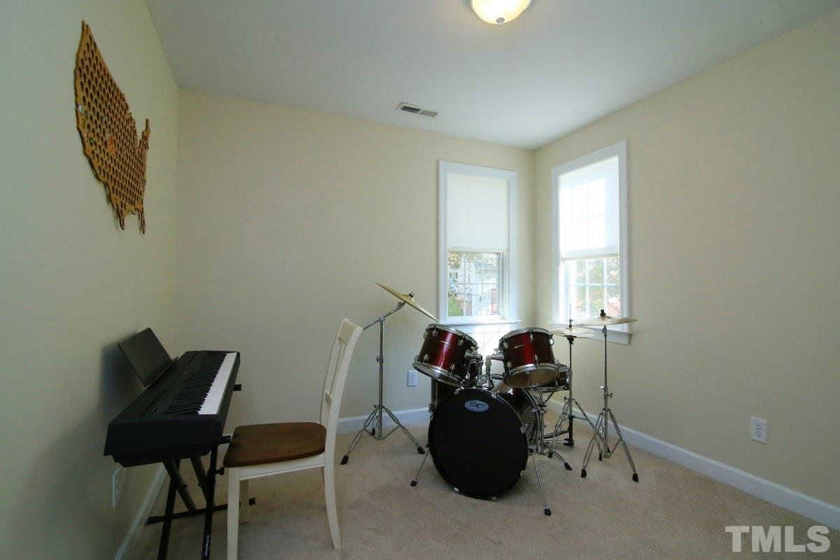 9212 Pennythorne Court Raleigh, NC 27615 - Photo 24 of 25 a living room with furniture and a window