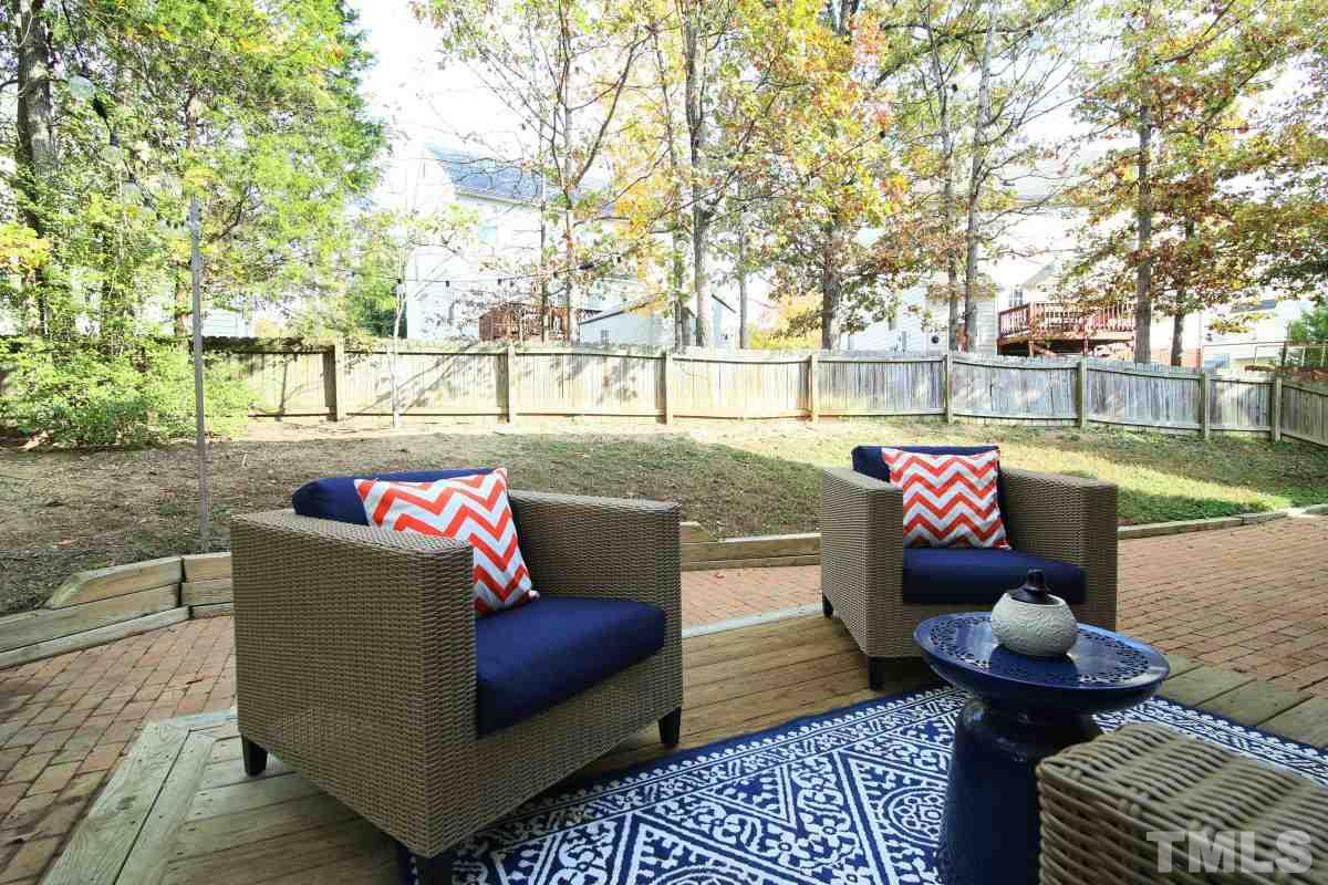 9212 Pennythorne Court Raleigh, NC 27615 - Photo 5 of 25 a outdoor living space with patio furniture and a potted plant