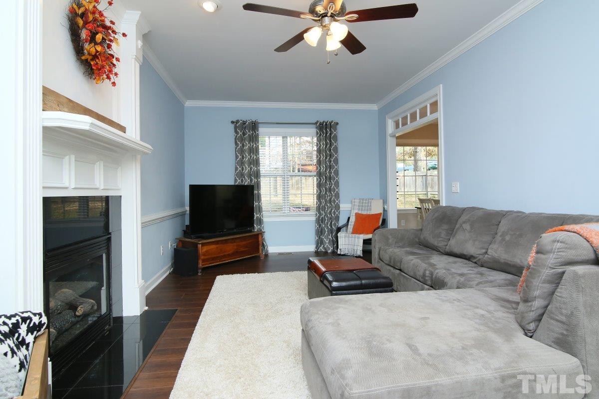 9212 Pennythorne Court Raleigh, NC 27615 - Photo 8 of 25 a living room with furniture and a flat screen tv