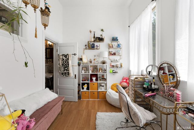 a living room with furniture and a book shelf