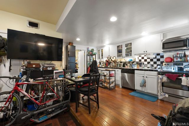 a kitchen area with stainless steel appliances kitchen island granite countertop a stove and cabinets