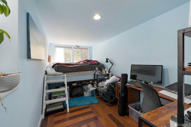 a bedroom with a bed and a tv