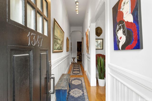 a view of an entryway with wooden floor