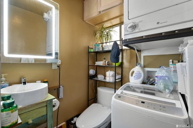 a bathroom with a sink mirror vanity and toilet