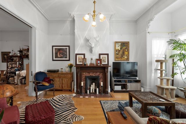a living room with furniture a fireplace and a flat screen tv