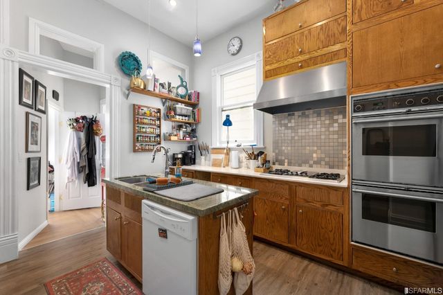 a kitchen with stainless steel appliances granite countertop a sink stove and refrigerator