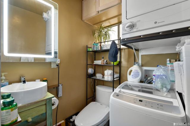 a bathroom with a mirror shower vanity and a sink