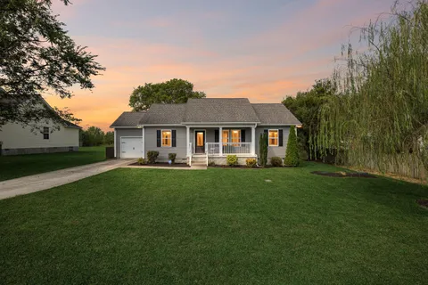 a front view of a house with a garden