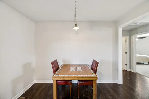 a view of a workspace with furniture and wooden floor