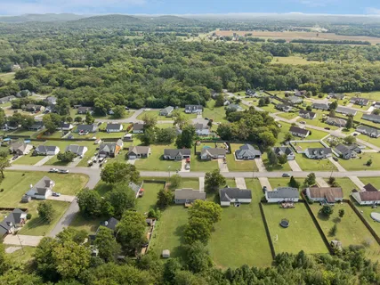 an aerial view of residential houses with outdoor space and swimming pool