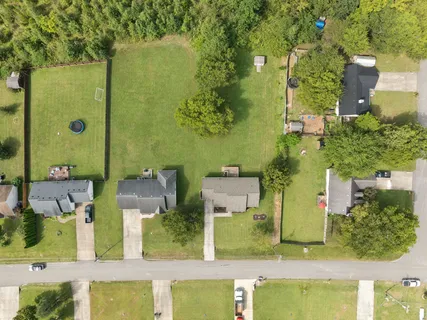 an aerial view of residential houses with outdoor space