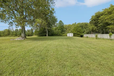 a living room with furniture a window and wooden floor