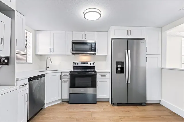 a kitchen with stainless steel appliances a refrigerator stove and microwave