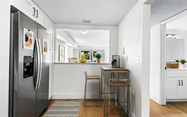 a kitchen with stainless steel appliances granite countertop a refrigerator and a stove top oven