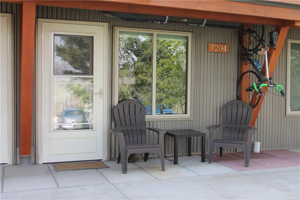 7204 Ryan Gulch Road, Unit 7204 Silverthorne, CO 80498 - Photo 1 of 17 a room with furniture and a window