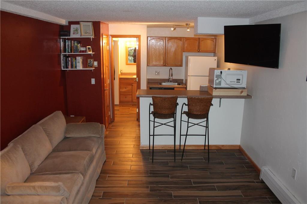 7204 Ryan Gulch Road, Unit 7204 Silverthorne, CO 80498 - Photo 3 of 17 a living room with furniture and a flat screen tv