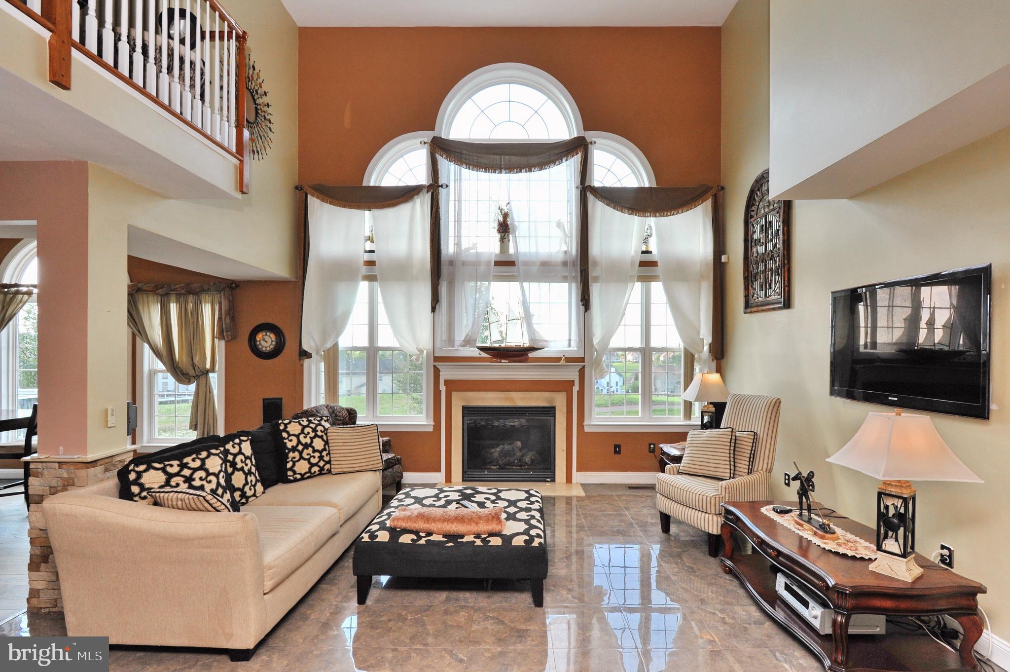 434 Hoffman Road Harleysville, PA 19438 - Photo 16 of 46 a living room with furniture a fireplace and a flat screen tv