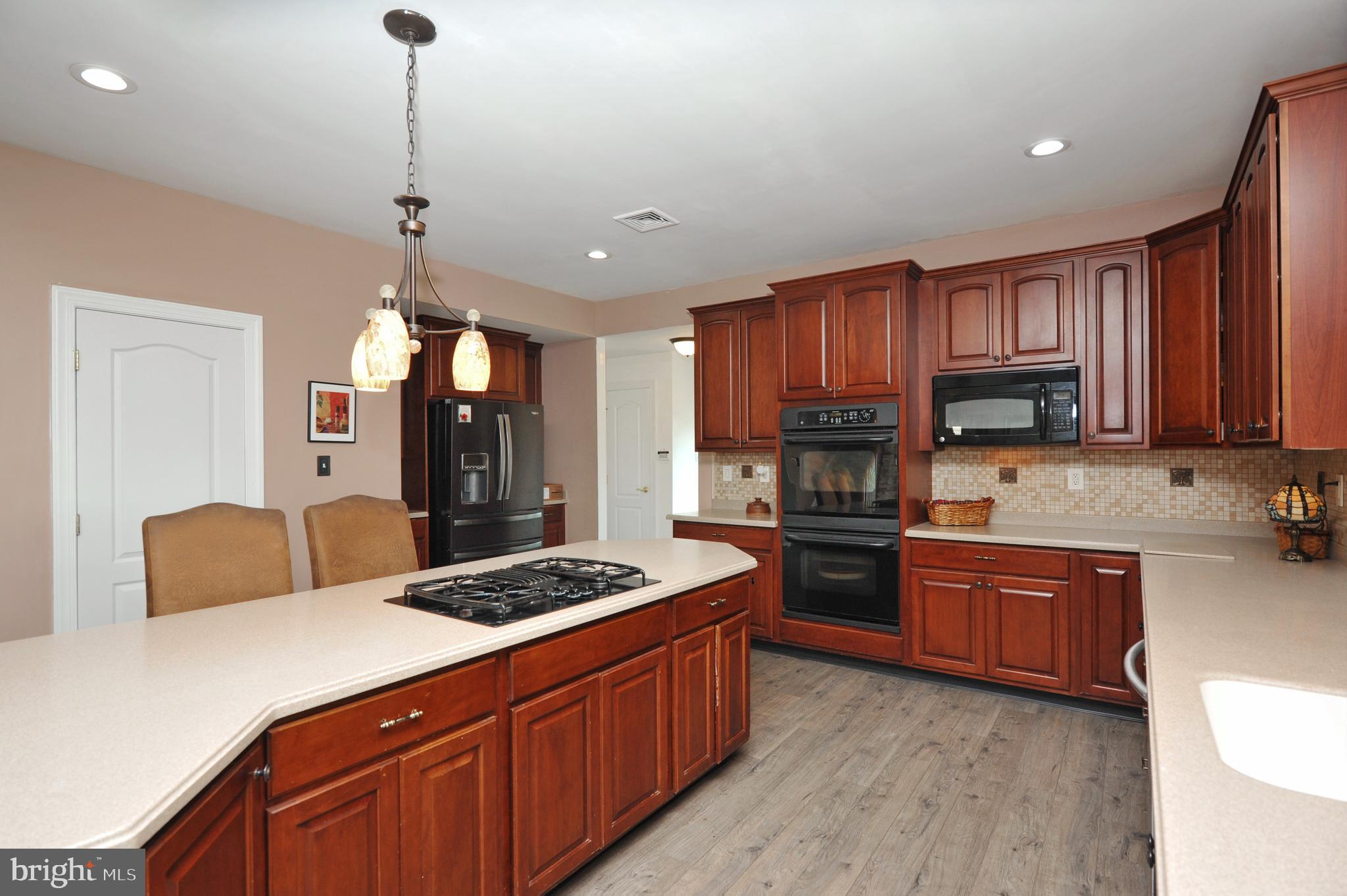434 Hoffman Road Harleysville, PA 19438 - Photo 18 of 46 a kitchen with stainless steel appliances granite countertop a stove refrigerator and cabinets