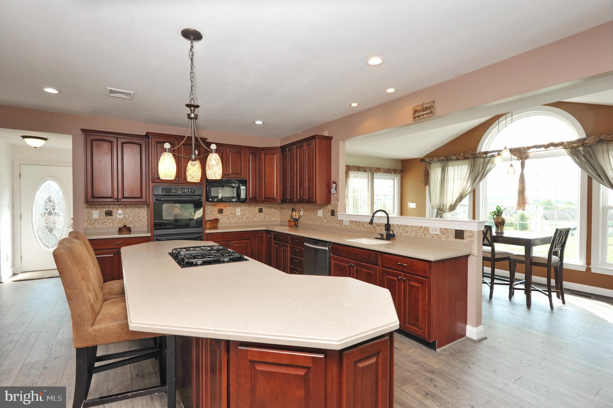 434 Hoffman Road Harleysville, PA 19438 - Photo 21 of 46 a kitchen with a dining table chairs sink and cabinets